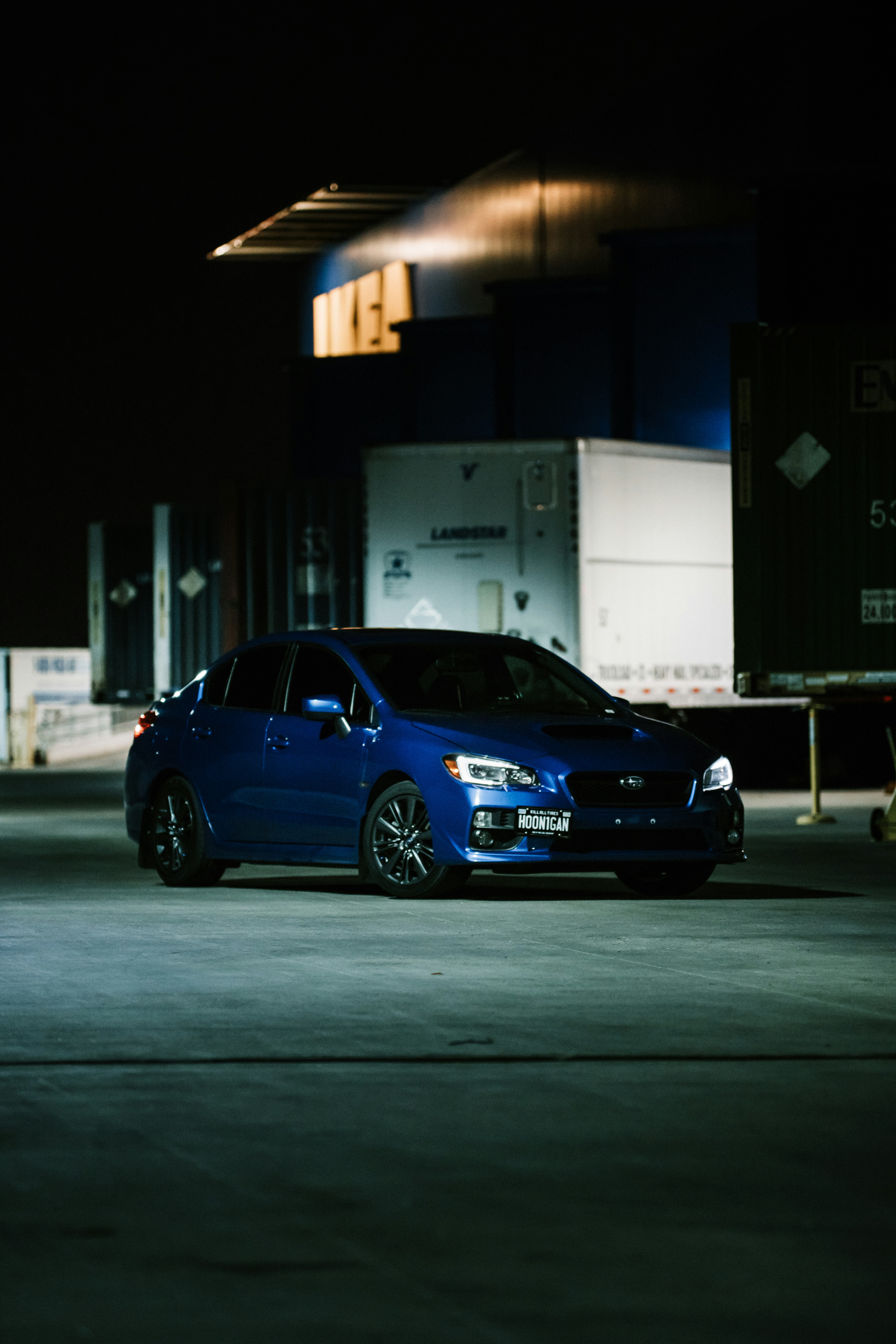 blue sedan parked on parking lot